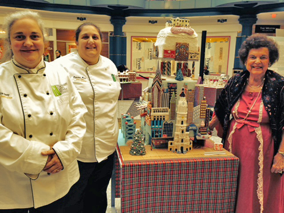 Julia Quay and Francine Marz. from the Culinary Arts Institute of Montgomery County Community College creators of the Laurel Hill Mansion Gingerbread House with the chairwomen of the board of Women for Greater Philadelphia, Alma Jacobs