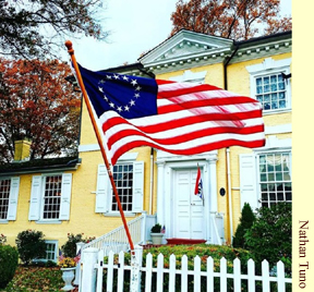 A colonial flag waves in the breeze outside Laurel Hill Mansion. 