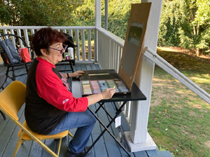 A participant in the Fall 2022 Plein Air painting workshop given at Laurel Hill Mansion by artist Joe Sweeney